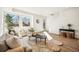 Bright living room features a large window, stylish furniture, and an eye-catching floral-patterned rug at 1416 Pierce St, Lakewood, CO 80214
