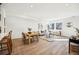 Open-concept living room and dining room with modern decor, hardwood floors, and lots of natural light at 1416 Pierce St, Lakewood, CO 80214