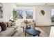 Cozy living room featuring neutral tones, a large window, comfortable seating, and modern decor at 1416 Pierce St, Lakewood, CO 80214