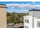 A view from a modern townhome shows distant mountains, neighborhood street, and mature tree canopy at 1416 Pierce St, Lakewood, CO 80214
