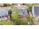 Aerial view of the home with a large backyard, mature trees, and a shed for storage at 21524 E Powers Pl, Centennial, CO 80015