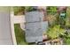 Birds eye view of the property showing a roof, deck, patio, well-maintained lawn, and surrounding greenery at 21524 E Powers Pl, Centennial, CO 80015
