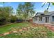 Private backyard with a cozy sunroom, lush lawn, brick path, and space for outdoor activities at 21524 E Powers Pl, Centennial, CO 80015