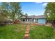 Lush backyard featuring a brick path, well-maintained lawn, and mature trees at 21524 E Powers Pl, Centennial, CO 80015