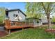 Spacious backyard featuring a deck, lush lawn, and mature trees for shade at 21524 E Powers Pl, Centennial, CO 80015
