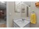 Updated bathroom with a white sink, a large mirror, and a neutral colored floor at 21524 E Powers Pl, Centennial, CO 80015