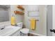 Bright bathroom featuring a white sink and toilet, light colored walls, and neutral flooring at 21524 E Powers Pl, Centennial, CO 80015