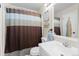 Clean bathroom featuring a white sink, decorative shower curtain, and a well-lit mirror at 21524 E Powers Pl, Centennial, CO 80015