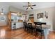 Open-concept kitchen and dining room featuring hardwood floors, stylish table with seating for six and a view of the kitchen at 21524 E Powers Pl, Centennial, CO 80015