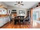 Charming dining area with a rustic wood table, black chairs, and hardwood floors at 21524 E Powers Pl, Centennial, CO 80015