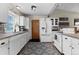 Bright kitchen features white cabinetry, stainless steel appliances, decorative rug and natural light at 21524 E Powers Pl, Centennial, CO 80015