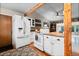 Modern kitchen with white cabinets, updated appliances, and hardwood floors at 21524 E Powers Pl, Centennial, CO 80015