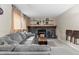 Cozy living room with a stone fireplace, gray sofa, and wooden accents at 21524 E Powers Pl, Centennial, CO 80015