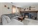 Inviting living room with a stone fireplace, gray sofa, and wooden accents at 21524 E Powers Pl, Centennial, CO 80015