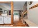 Open-concept living room featuring hardwood floors, built-in bookshelves, and abundant natural light at 21524 E Powers Pl, Centennial, CO 80015