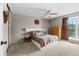 Cozy main bedroom features a large bed, side tables, and a large window at 21524 E Powers Pl, Centennial, CO 80015