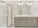 This bathroom features a double sink vanity, full mirror, and a glass enclosed shower at 27694 E Byers Ave, Aurora, CO 80018