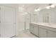 This bathroom features a double sink vanity, full mirror, and a glass enclosed shower at 27694 E Byers Ave, Aurora, CO 80018