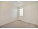 This bedroom features neutral carpet, baseboard trim, and a bright window at 27694 E Byers Ave, Aurora, CO 80018