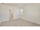 This bedroom features neutral carpet, baseboard trim, and an attached bathroom at 27694 E Byers Ave, Aurora, CO 80018