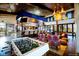 Spacious game room inside clubhouse with bar, ample seating, and foosball table at 27694 E Byers Ave, Aurora, CO 80018