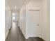 Clean, bright hallway with modern flooring and neutral walls, leading to various rooms in the home at 27694 E Byers Ave, Aurora, CO 80018