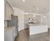Modern kitchen with stainless steel appliances, granite counters, and gray cabinets with backsplash at 27694 E Byers Ave, Aurora, CO 80018