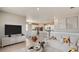 Bright, open living space featuring modern furnishings and decor with a view to the kitchen and dining area at 27694 E Byers Ave, Aurora, CO 80018