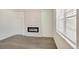 Bright living room featuring a modern fireplace with white brick surround and lots of natural light at 27694 E Byers Ave, Aurora, CO 80018