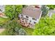 Aerial view of the home's backyard featuring an outdoor deck, mature trees, and lawn at 2795 Signal Creek Dr, Thornton, CO 80241