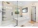 Bathroom featuring a walk-in shower, soaking tub, and natural light from a bright window at 2795 Signal Creek Dr, Thornton, CO 80241