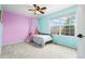 Bright bedroom featuring colorful walls, ceiling fan, and exterior view through window at 2795 Signal Creek Dr, Thornton, CO 80241