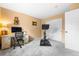 Comfortable bedroom featuring home office setup, exercise bike, and closet at 2795 Signal Creek Dr, Thornton, CO 80241
