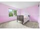 Charming bedroom with pink walls, a cozy bed, and a view of the neighborhood at 2795 Signal Creek Dr, Thornton, CO 80241