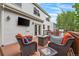 Inviting backyard deck features outdoor seating, flat-screen tv, and lush landscaping at 2795 Signal Creek Dr, Thornton, CO 80241