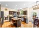 Updated kitchen features granite countertops, stainless appliances, a center island, and hardwood floors at 2795 Signal Creek Dr, Thornton, CO 80241