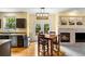 Bright kitchen and eat-in area with backyard access and fireplace in the living room at 2795 Signal Creek Dr, Thornton, CO 80241