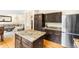 Kitchen island with granite countertop opens to a large living room and stainless steel appliances at 2795 Signal Creek Dr, Thornton, CO 80241
