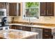 Bright kitchen featuring granite countertops, stainless steel appliances, and a view of the backyard at 2795 Signal Creek Dr, Thornton, CO 80241