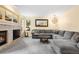 Cozy living room with a fireplace, plush seating, and natural light from the window at 2795 Signal Creek Dr, Thornton, CO 80241