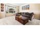 Comfortable living room featuring plush carpeting, a large sectional sofa, and a decorative coffee table with a large bright window at 2795 Signal Creek Dr, Thornton, CO 80241