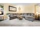 Spacious living room with plush sectional sofa, and decorative mirror at 2795 Signal Creek Dr, Thornton, CO 80241