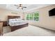 Light-filled main bedroom features tray ceilings, soft carpeting, and a large picture window at 2795 Signal Creek Dr, Thornton, CO 80241