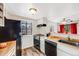 Galley kitchen, black appliances, wood floor at 12490 E Cornell Ave # 301, Aurora, CO 80014