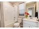 Well-lit bathroom with a shower-tub combo, modern vanity, and stylish floral accents at 1312 Independence St # 3, Lakewood, CO 80215
