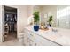 Bathroom with walk-in closet, double sinks, a big mirror and white cabinets at 1312 Independence St # 3, Lakewood, CO 80215