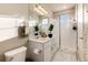 Modern bathroom with double sinks, large mirror, glass enclosed shower and a large window for natural light at 1312 Independence St # 3, Lakewood, CO 80215