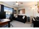 Bedroom features a large window, American flag decor, black sofa and keyboard at 1312 Independence St # 3, Lakewood, CO 80215