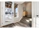 Bright entryway featuring stylish wood-look floors, a storage cabinet, and a clear view to the outdoors through a glass door at 1312 Independence St # 3, Lakewood, CO 80215