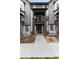Exterior view of townhome with gray and white siding, brick accents, and covered balcony at 1312 Independence St # 3, Lakewood, CO 80215